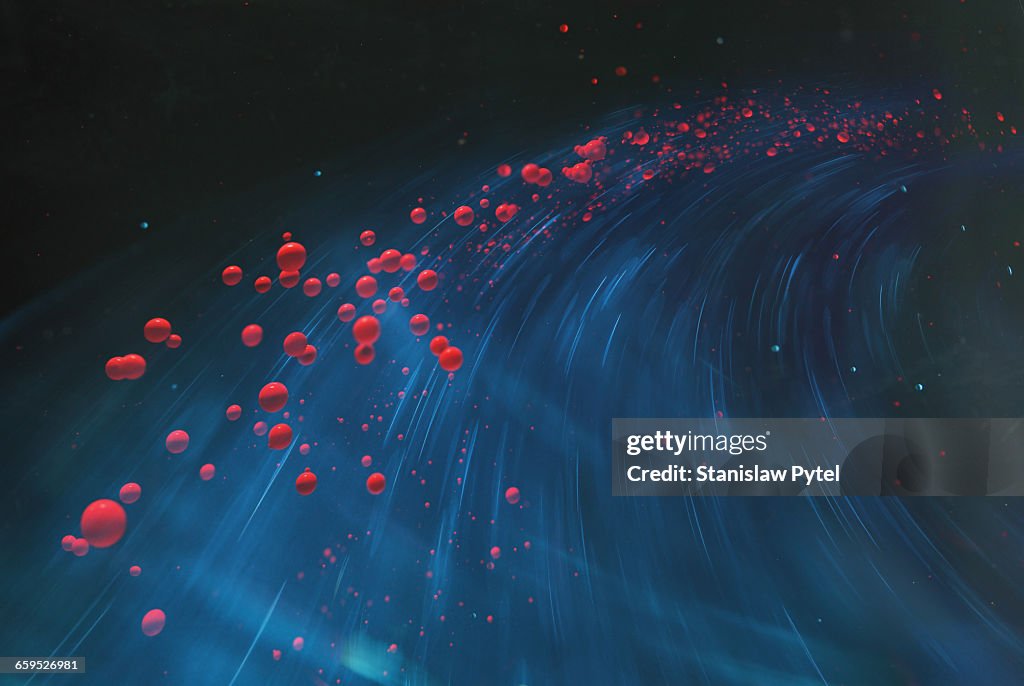 Red spheres flying on blue background