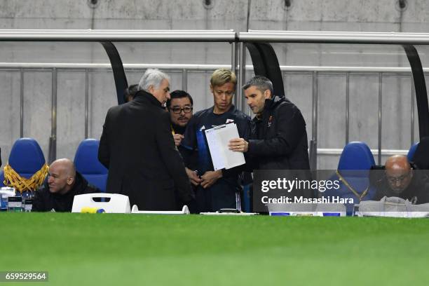 Keisuke Honda of Japan is instructed by Head coach Vahid Halilhodzic before being brought in as a substitute during the 2018 FIFA World Cup Qualifier...