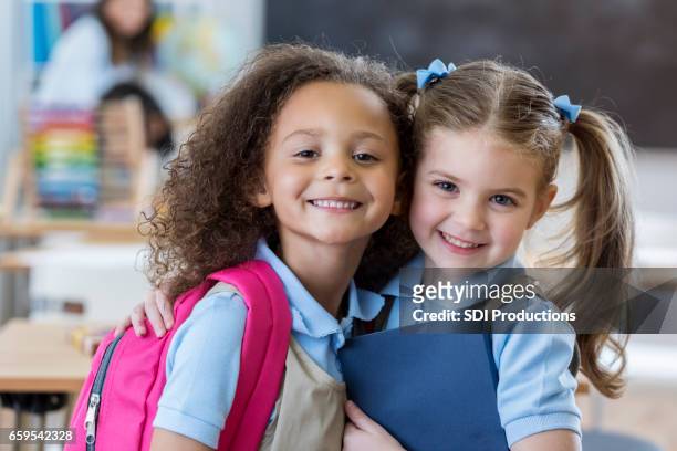 adorable schoolgirls in class - school uniform stock pictures, royalty-free photos & images