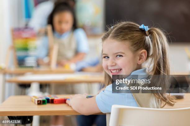 entzückende kindergartenkind in der klasse - erster schultag stock-fotos und bilder