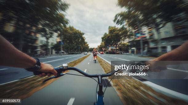 pov bicycle riding in the city, barcelona, spain - handlebar stock pictures, royalty-free photos & images