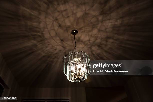 lighted chandelier in ceiling - plafond photos et images de collection