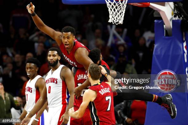 Hassan Whiteside of the Miami Heat celebrates his buzzer beating game winning basket with teammates in front of Andre Drummond of the Detroit Pistons...