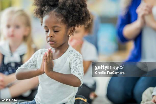 girl praying - child praying school stock pictures, royalty-free photos & images