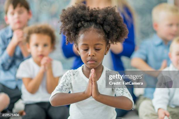 young girl praying - child praying school stock pictures, royalty-free photos & images