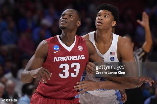 Moses Kingsley of the Arkansas Razorbacks and Isaiah Hicks of the North Carolina Tar Heels in action during the second round of the 2017 NCAA Men's...