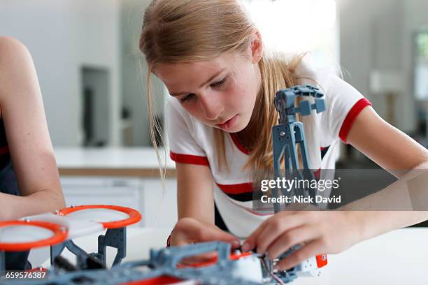 girls building a robot - budding tween stock pictures, royalty-free photos & images