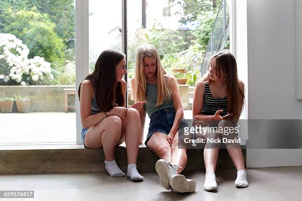 teenage girls chatting together - 13 year old girls in shorts stock pictures, royalty-free photos & images