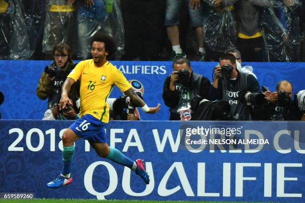 Brazil's midfielder Marcelo celebrates after scoring against Paraguay during their 2018 FIFA World Cup qualifier football match in Sao Paulo, Brazil...