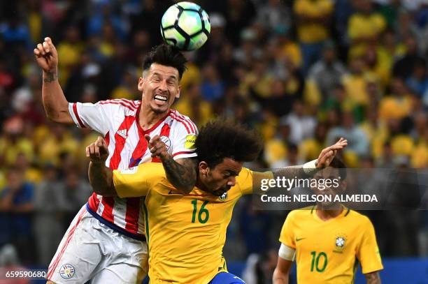 Paraguay's midfielder Edgar Benitez vies for the ball with Brazil's midfielder Marcelo during their 2018 FIFA World Cup qualifier football match in...