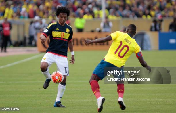 Guillermo Cuadrado of Colombia controls the ball as Walter Ayoví of Ecuador defends during a match between Ecuador and Colombia as part of FIFA 2018...