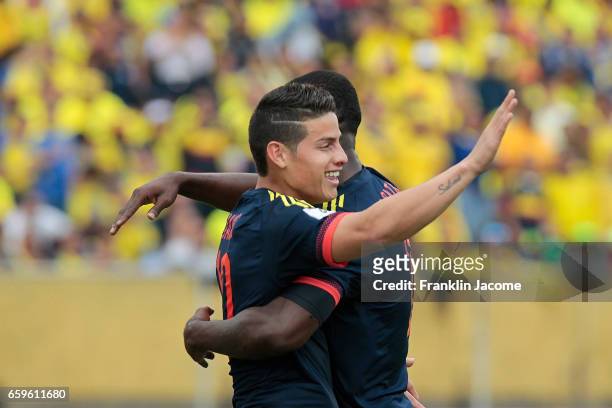James Rodríguez of Colombia celebrates with teammate Miguel Borja after scoring the opening goal during a match between Ecuador and Colombia as part...
