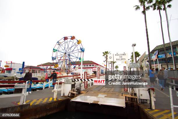 balboa island ferry approaching balboa fun zone, ca - newport beach california stock pictures, royalty-free photos & images