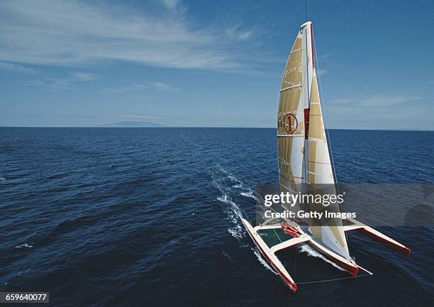 Yachtsmen Peter Blake and Mike Quilter of New Zealand sail the Steinlager 1 trimaran racer across the Pacific Ocean during the Bicentennial...