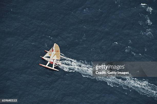 Yachtsmen Peter Blake and Mike Quilter of New Zealand sail the Steinlager 1 trimaran racer across the Pacific Ocean during the Bicentennial...