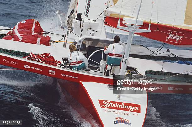 Yachtsmen Peter Blake and Mike Quilter of New Zealand sail the Steinlager 1 trimaran racer across the Pacific Ocean during the Bicentennial...