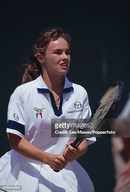 Czech born Swiss tennis player Martina Hingis pictured in action during competition in the Girls' Singles tournament at the Wimbledon Lawn Tennis...