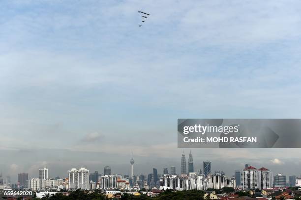 The Black Eagles, the aerobatic team of T-50 jets belonging to South Korea's air force, fly in formation above Malaysia's skyline during a flypast in...