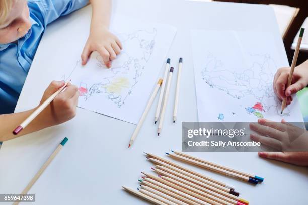 two school children doing school work - colouring stock pictures, royalty-free photos & images