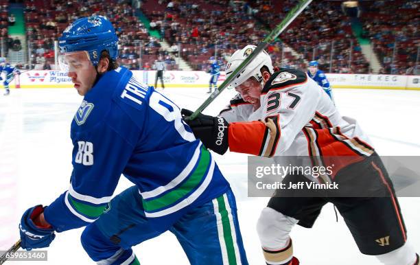 Nick Ritchie of the Anaheim Ducks checks Nikita Tryamkin of the Vancouver Canucks during their NHL game at Rogers Arena March 28, 2017 in Vancouver,...