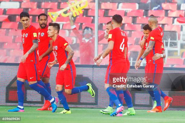 Alexis Sanchez of Chile celebrates with teammates after scoring the first goal of his team during a match between Chile and Venezuela as a part of...