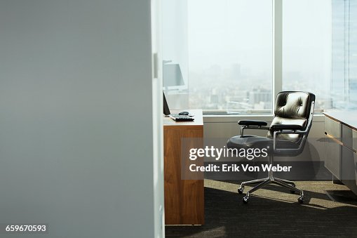 Bright corner office space with desk and chairs Bright corner office space with desk and chairs