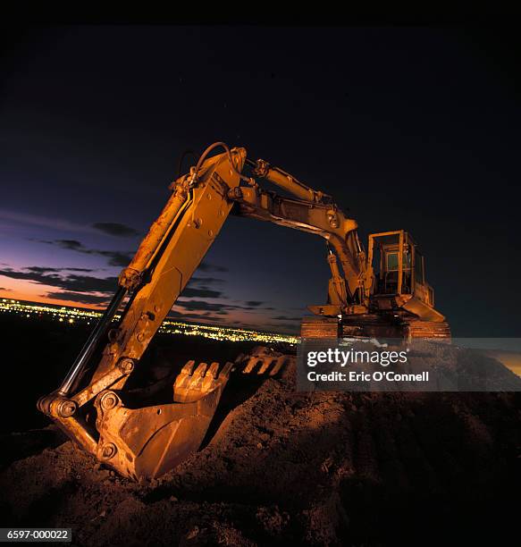 excavator at night - construction vehicles foto e immagini stock