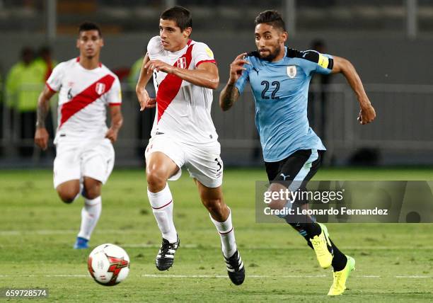 Jonathan Urretaviscaya of Uruguay struggles for the ball with Aldo Corzo of Peru during a match between Peru and Uruguay as part of FIFA 2018 World...