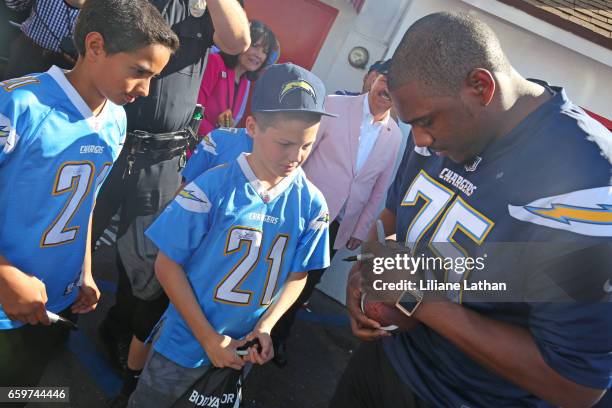Tackle Chris Hairston signs autograph for fans at the unveiling of the "Chargers Chilli Cheese" at Pink's Hot Dogs on March 14, 2017 in Los Angeles,...