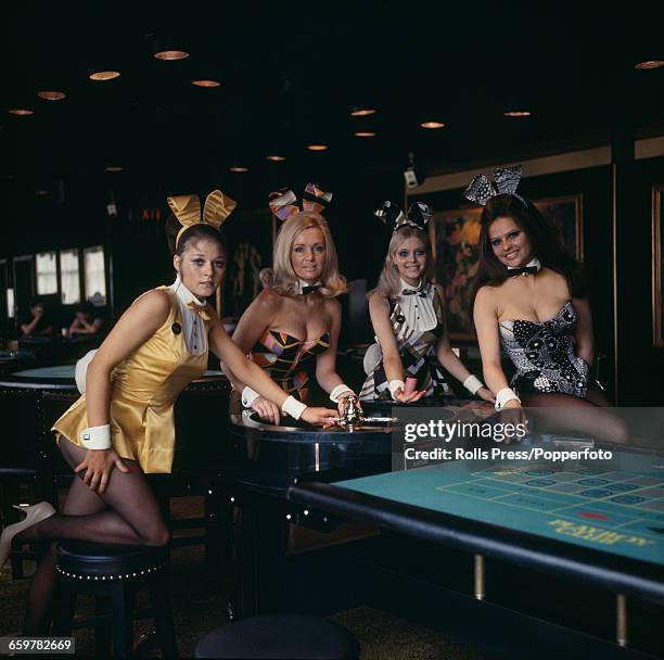 Four Bunny Girl croupiers pose together at the Playboy Club in Park Lane, London wearing both the newly introduced and old costumes at the club in...