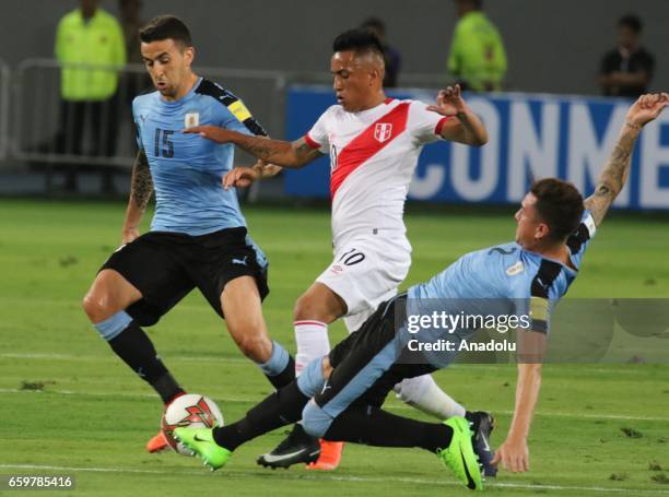 Christian Cueva of Peru in action against Matias Vecino and Jose Gimenez of Uruguay during 2018 FIFA World Cup Qualification match between Peru and...