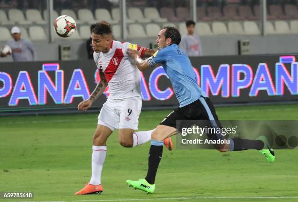 Paolo Guerrero of Peru in action against Diego Godin of Uruguay during 2018 FIFA World Cup Qualification match between Peru and Uruguay at National...