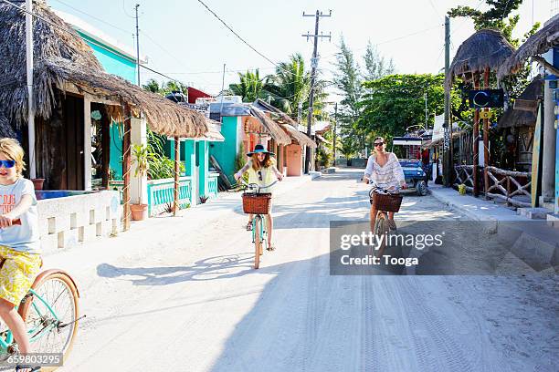 Family riding through small Mexican beach town