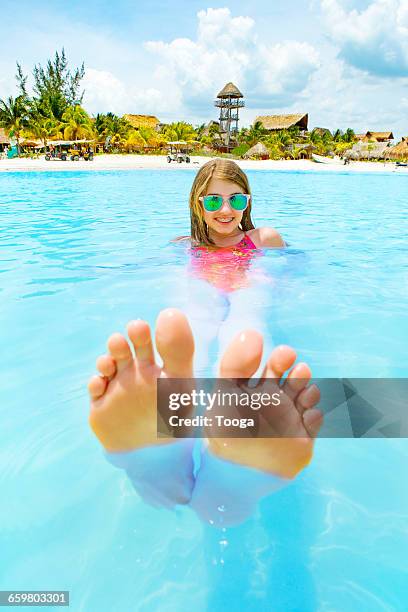 tween girl floating beautiful blue ocean - girls soles stock pictures, royalty-free photos & images