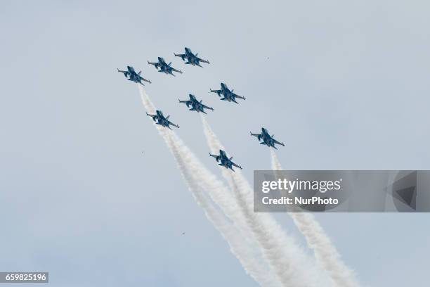 South Korean Air Force 'Black Eagles' aerobatic team flies past Petronas Twin Towers and KLCC area on March 29, 2017 in Kuala Lumpur, Malaysia