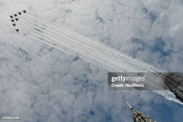 South Korean Air Force 'Black Eagles' aerobatic team flies past Petronas Twin Towers and KLCC area on March 29, 2017 in Kuala Lumpur, Malaysia