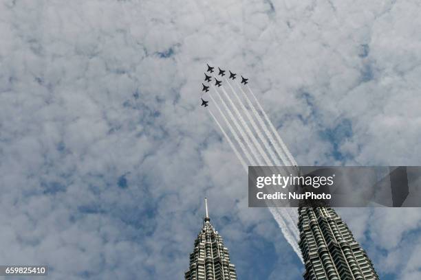 South Korean Air Force 'Black Eagles' aerobatic team flies past Petronas Twin Towers and KLCC area on March 29, 2017 in Kuala Lumpur, Malaysia