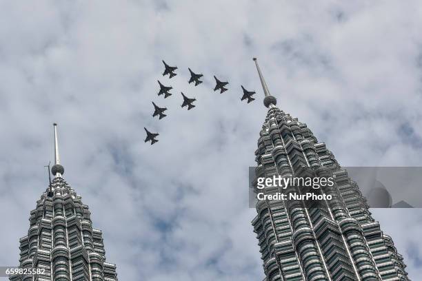 South Korean Air Force 'Black Eagles' aerobatic team flies past Petronas Twin Towers and KLCC area on March 29, 2017 in Kuala Lumpur, Malaysia