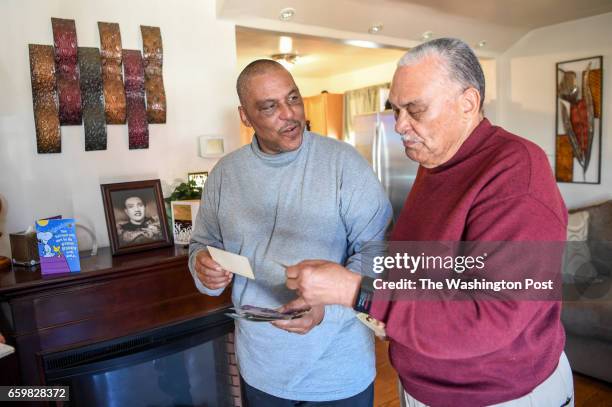 Lawrence Lacks and Ron Lacks the son and grandson of Henrietta Lacks, look at family photo's in Baltimore, MD on March 22, 2017.