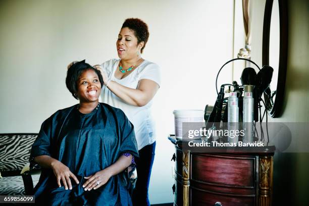 smiling woman having haircut in salon - hairdressers black woman stockfoto's en -beelden