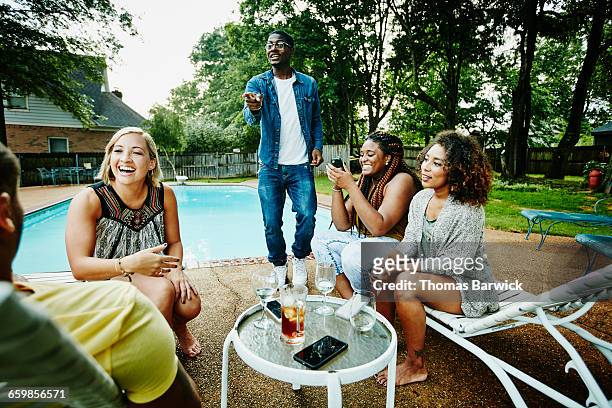 smiling group of friends hanging out by pool - body issue celebration party stock pictures, royalty-free photos & images