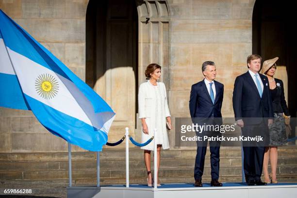 King Willem-Alexander and Queen Maxima of The Netherlands welcome President Mauricio Macri during an official welcome ceremony at the Royal Palace on...