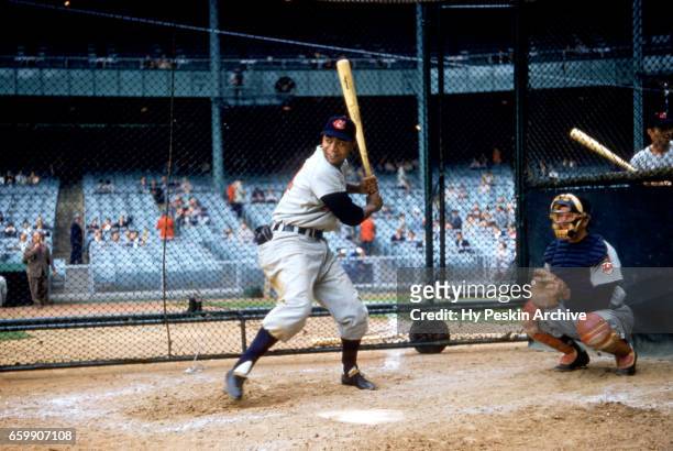 Larry Doby of the Cleveland Indians hits in the batting cage before an MLB game against the New York Yankees on May 11, 1955 at Yankee Stadium in the...