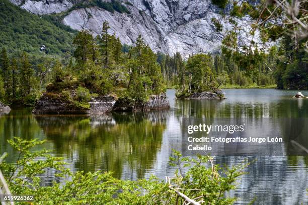 islets of lake quetrus and granite walls - américa del sur ストックフォトと画像