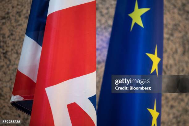 The Union flag, also known as the Union Jack, left, stands next to a European Union flag inside the Justus Lipsius building of the European Council...