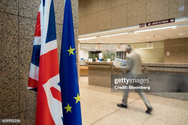 The Union flag, also known as the Union Jack, left, stands next to a European Union flag inside the Justus Lipsius building of the European Council...