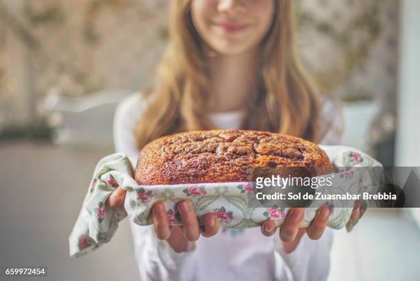 delicious vanilla and chocolate biscuit held in the hands of a blonde girl - niñez stockfoto's en -beelden