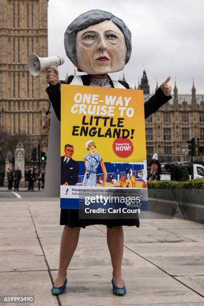 Pro-EU protester dressed as Prime Minister Theresa May takes part in a demonstration near Parliament on March 29, 2017 in London, England. . Later...