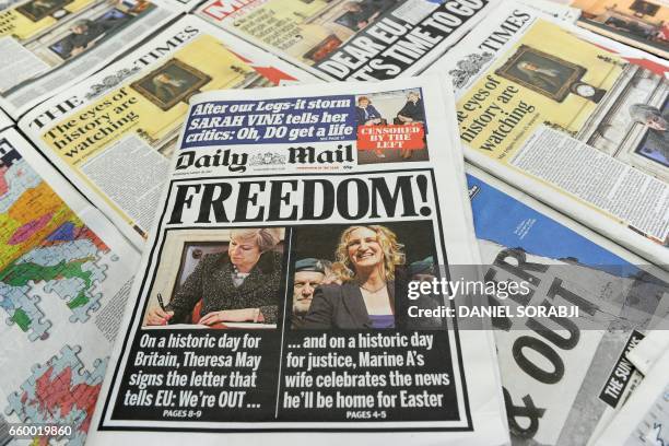 An arrangement of newspapers pictured in London on March 29 as an illustration, shows the front pages of the UK daily newspapers reporting on British...