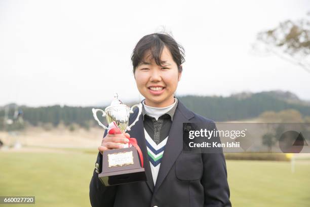 Miyu Sato holds a trophy after the match during the final round of the Rashink Nijinia/RKB Ladies at the Queens Hill Golf Club on March 29, 2017 in...